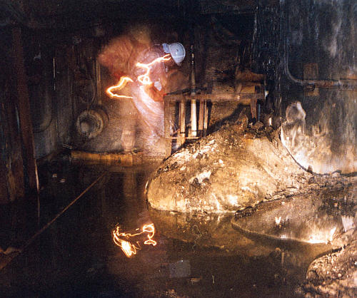 Artur Korneev, Deputy Director of Shelter Object, viewing
	    the elephants foot lava flow, Chornobyl NPP. Photographer:
	    Unknown. Fall 1996. [US DOE]